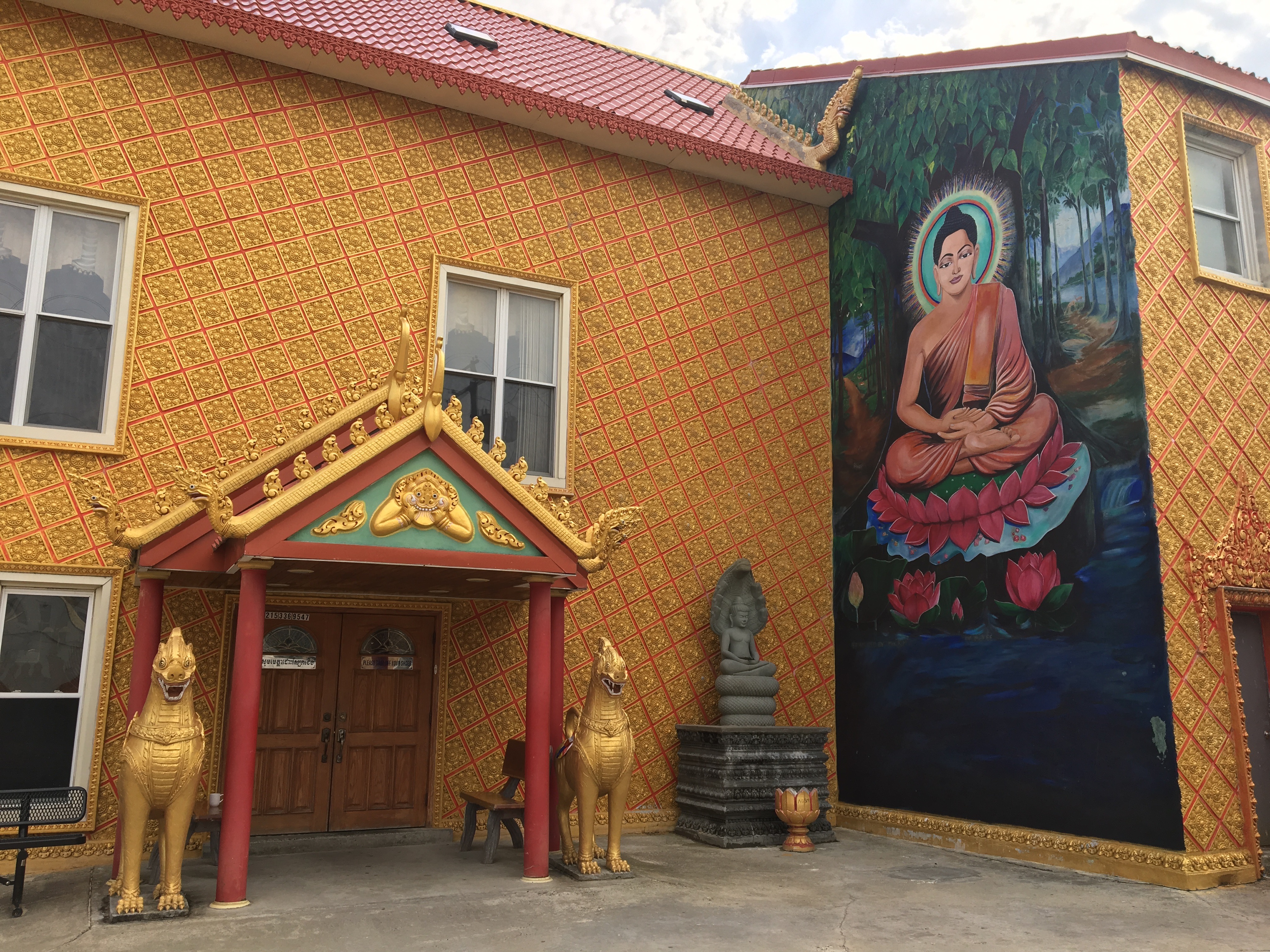 Main building, exterior wall with statues and mural
